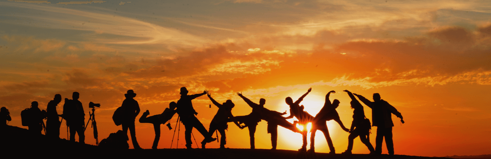 A community gathered beneath a warm sunrise