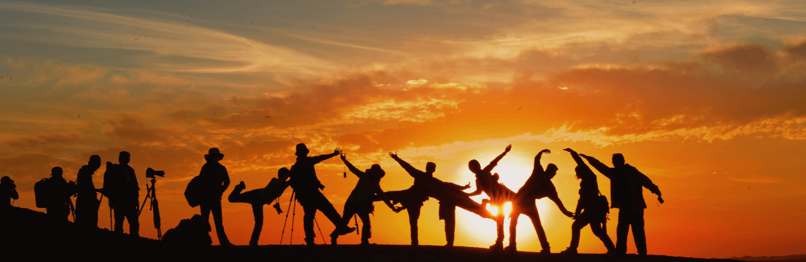 A community gathered beneath a warm sunrise